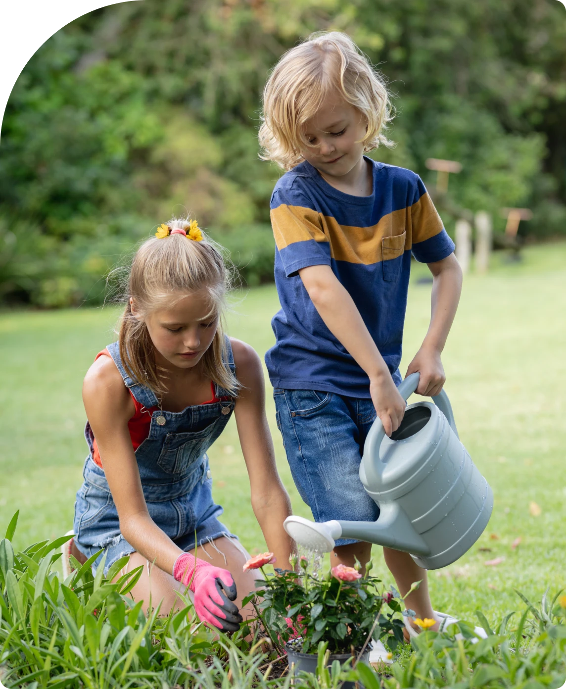 Kids planting flowers in a garden